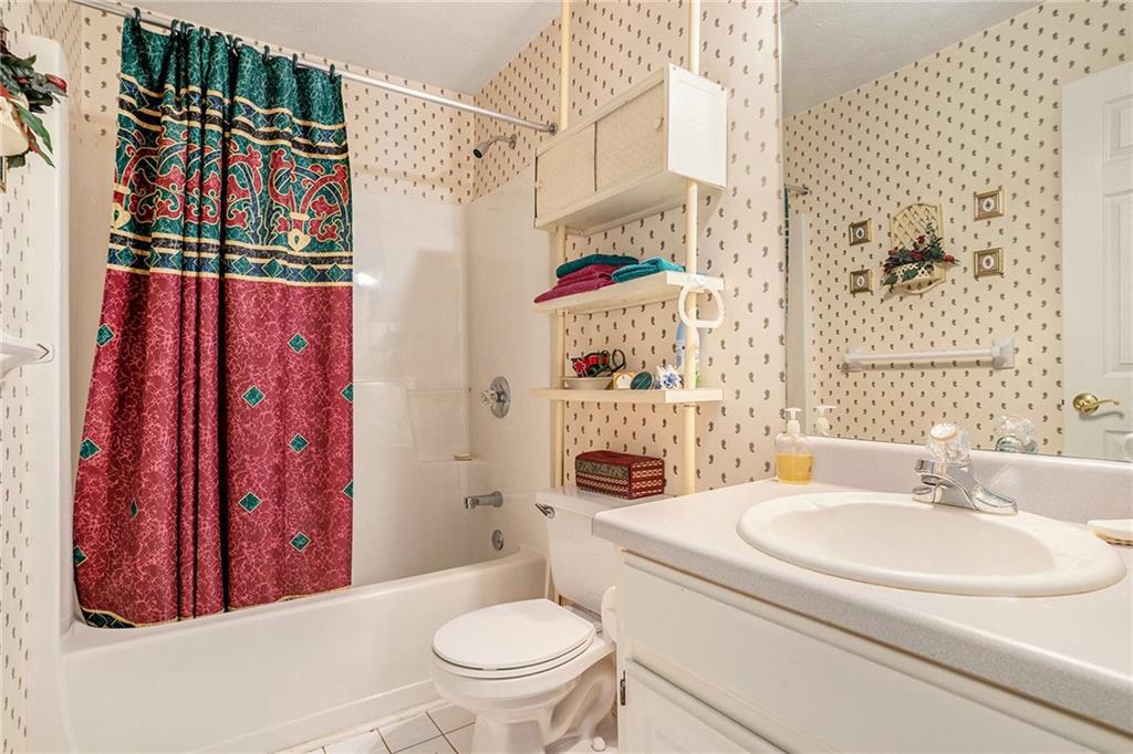 30 Spring Valley Drive Covington, GA 30016 - Photo 22 of 28 a bathroom with a sink toilet and shower