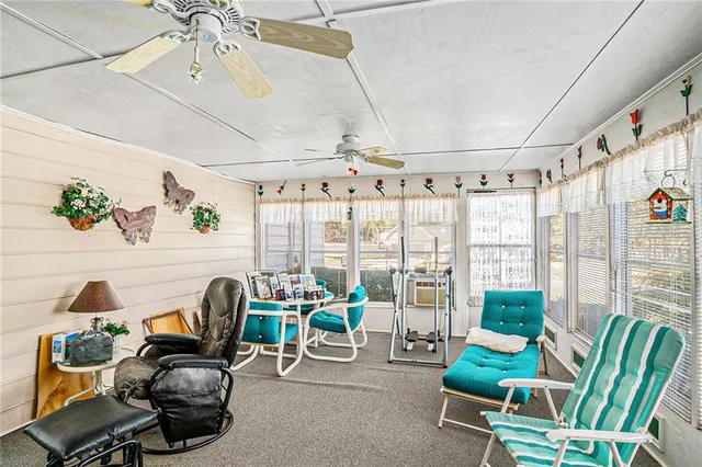 a living room with furniture and a floor to ceiling window
