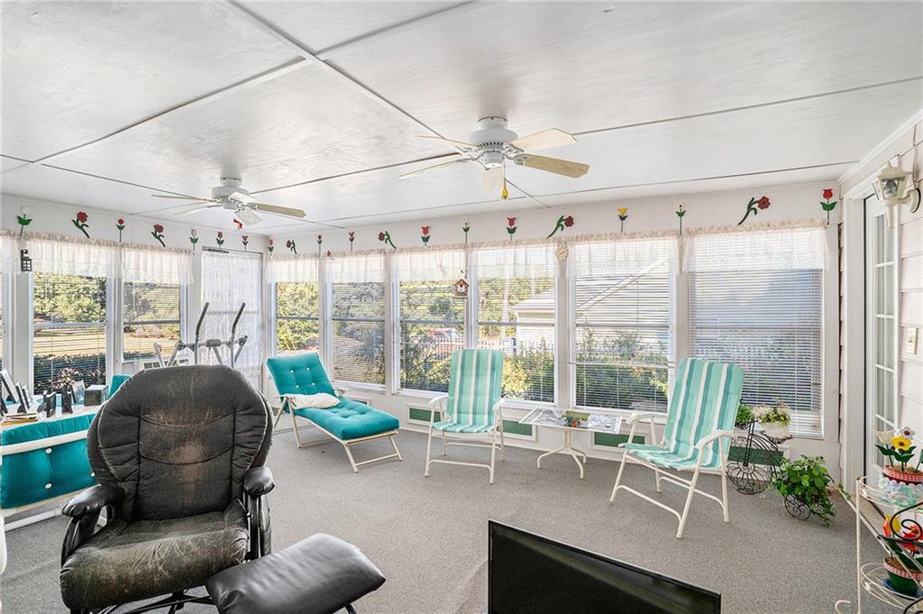 30 Spring Valley Drive Covington, GA 30016 - Photo 25 of 28 a living room with furniture and a floor to ceiling window