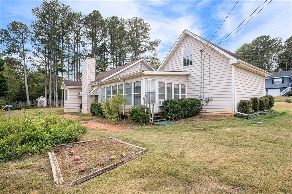 30 Spring Valley Drive Covington, GA 30016 - Photo 28 of 28 a view of a house with backyard and trees