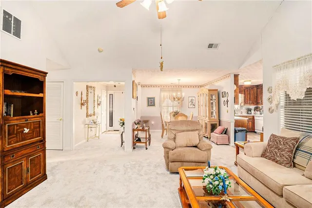 a living room with furniture and chandelier
