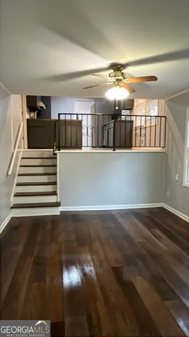 a view of entryway and hall with wooden floor