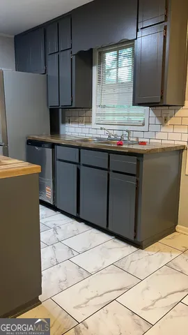 a kitchen with stainless steel appliances granite countertop a refrigerator and a stove