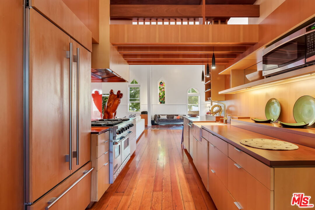 2621 2nd Street Santa Monica, CA 90405 - Photo 13 of 33 a kitchen with stainless steel appliances granite countertop a stove and a refrigerator