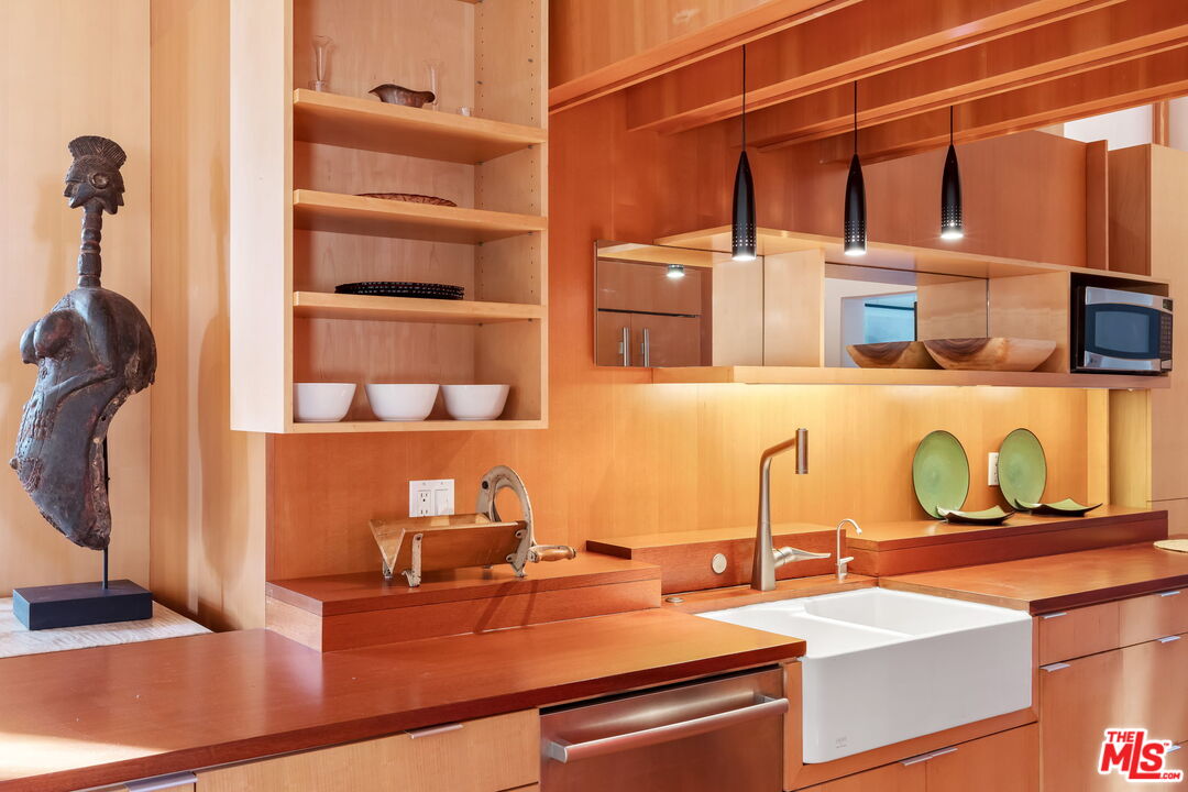 2621 2nd Street Santa Monica, CA 90405 - Photo 14 of 33 a kitchen with a sink and a stove with wooden floor