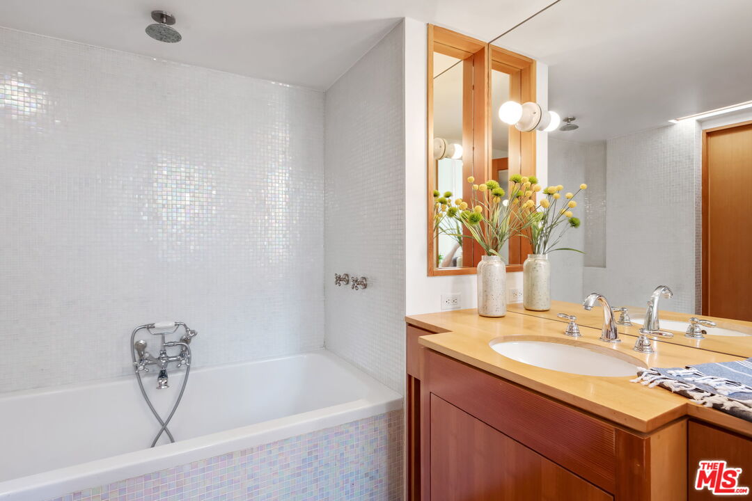 2621 2nd Street Santa Monica, CA 90405 - Photo 20 of 33 a bathroom with a granite countertop sink and a mirror