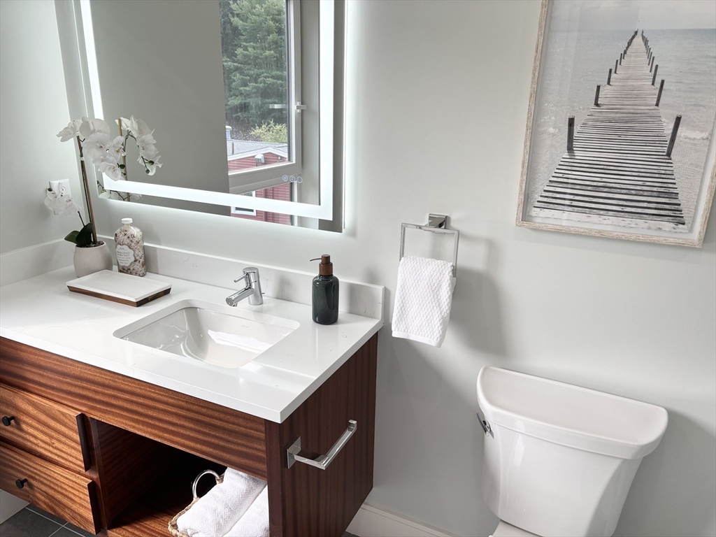 1391 Main Street, Unit 304 Walpole, MA 02081 - Photo 20 of 34 a bathroom with a sink a toilet and a window