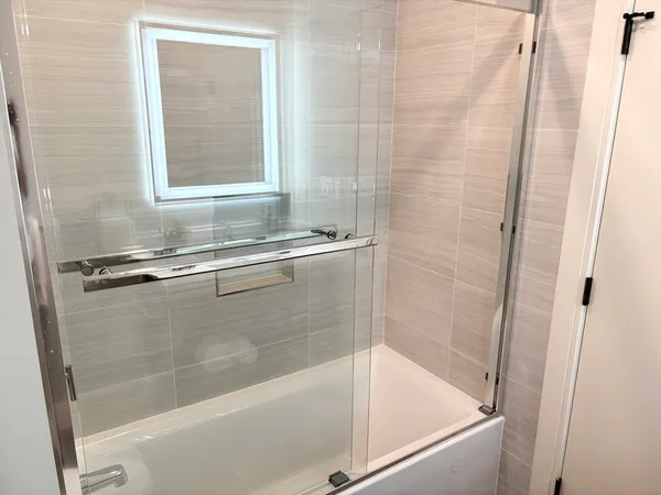 a bath tub sitting next to a shower