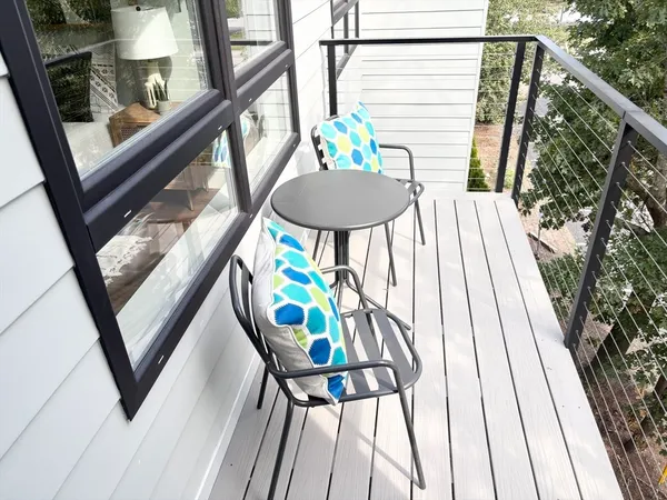 a balcony with table and chairs