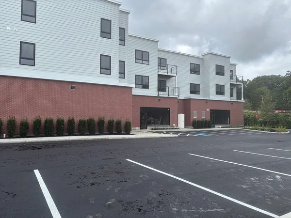 a front view of a building with a road