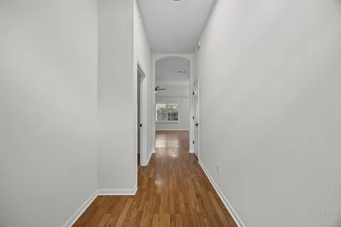 a view of a hallway with wooden floor