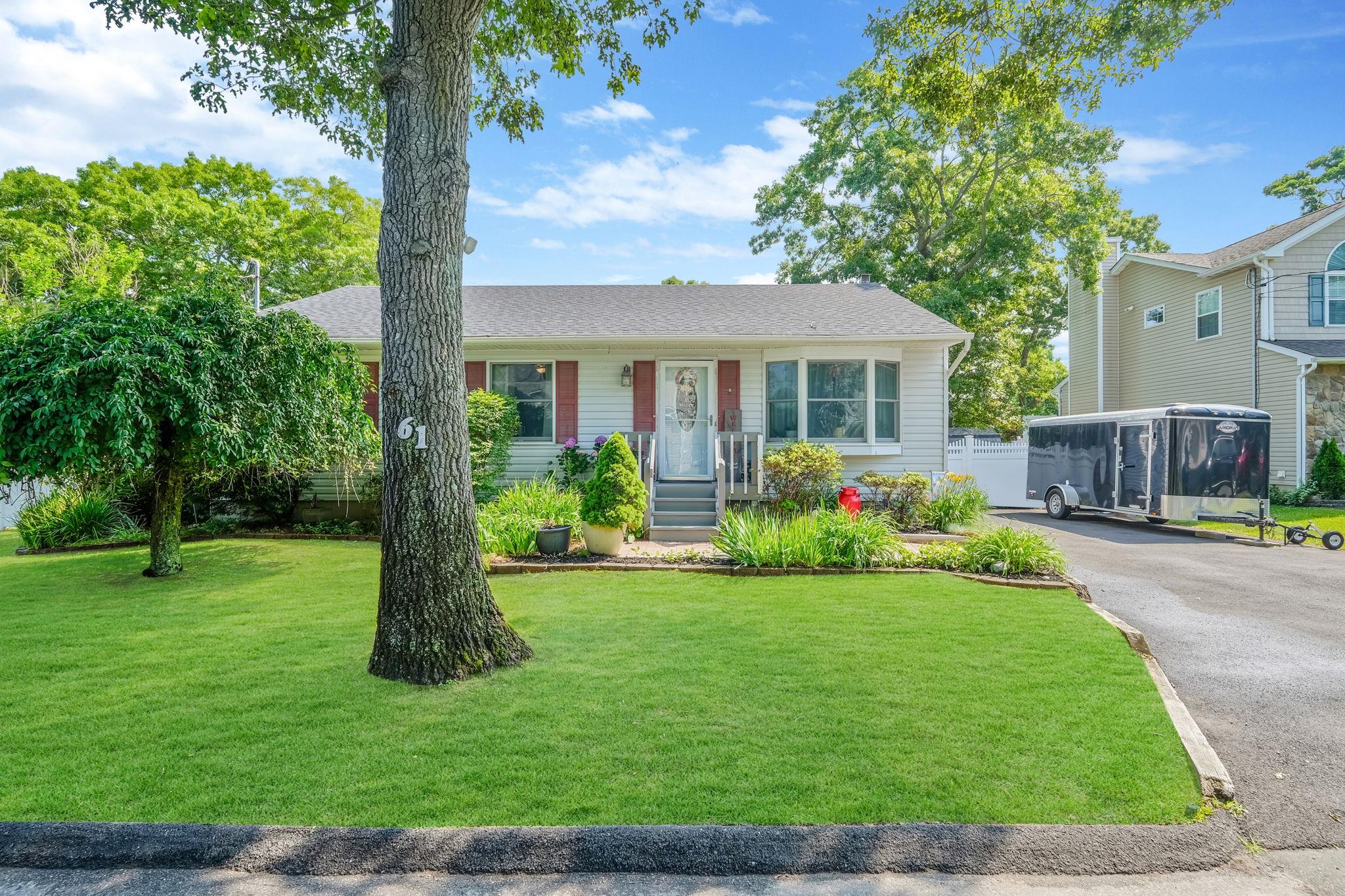 a front view of house with yard and green space