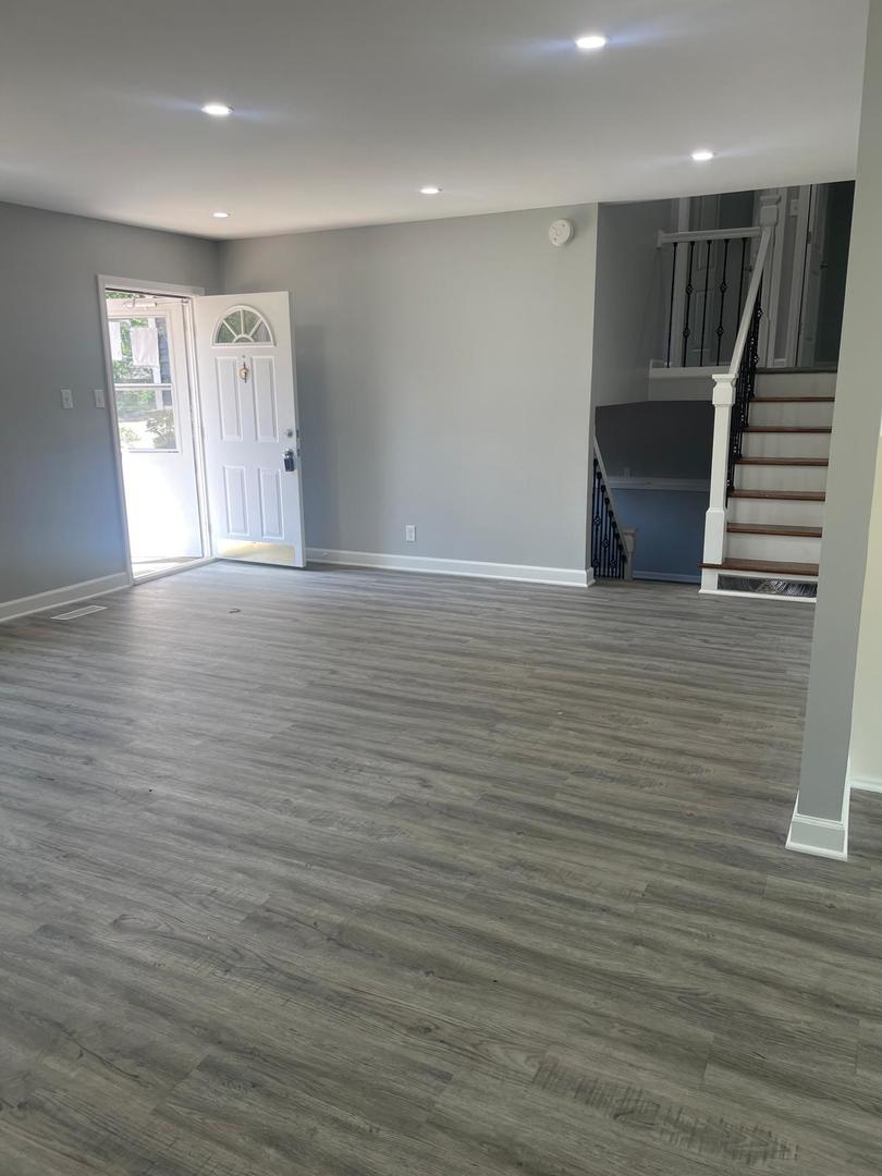 573 Redwood Road Bolingbrook, IL 60440 - Photo 13 of 24 a view of an empty room with wooden floor and stairs