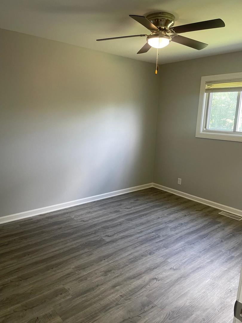 573 Redwood Road Bolingbrook, IL 60440 - Photo 14 of 24 a view of an empty room with wooden floor and a window