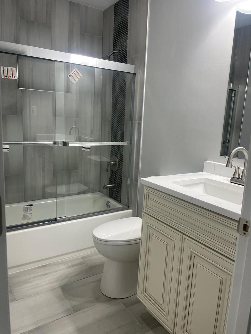 573 Redwood Road Bolingbrook, IL 60440 - Photo 17 of 24 a bathroom with a sink toilet and shower