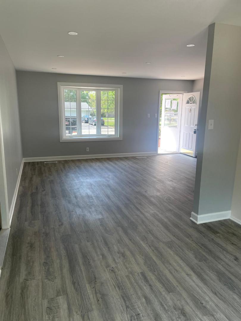 573 Redwood Road Bolingbrook, IL 60440 - Photo 19 of 24 an empty room with wooden floor and windows
