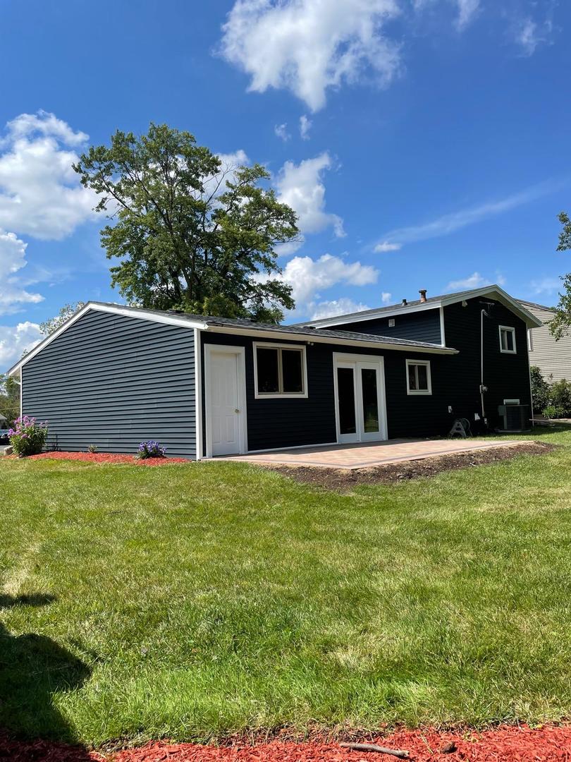 573 Redwood Road Bolingbrook, IL 60440 - Photo 2 of 24 a front view of a house with a garden
