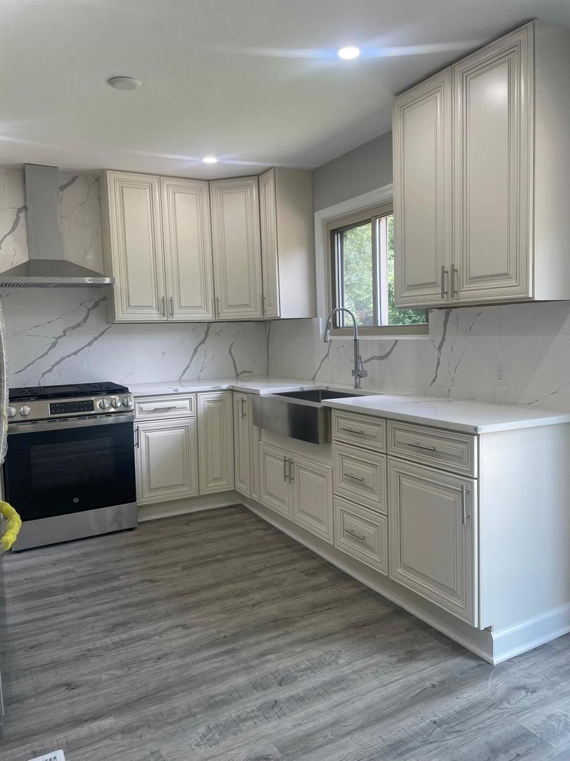 573 Redwood Road Bolingbrook, IL 60440 - Photo 3 of 24 a kitchen with granite countertop a sink stainless steel appliances and cabinets