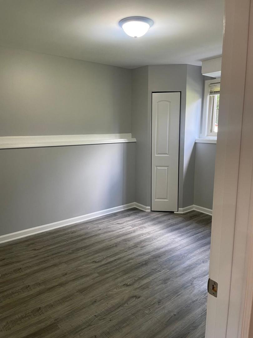 573 Redwood Road Bolingbrook, IL 60440 - Photo 6 of 24 an empty room with wooden floor & closet area