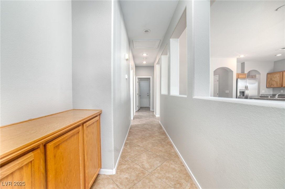 4020 Spring Line Street North Las Vegas, NV 89032 - Photo 14 of 29 Hallway featuring light tile patterned floors, arched walkways, and recessed lighting