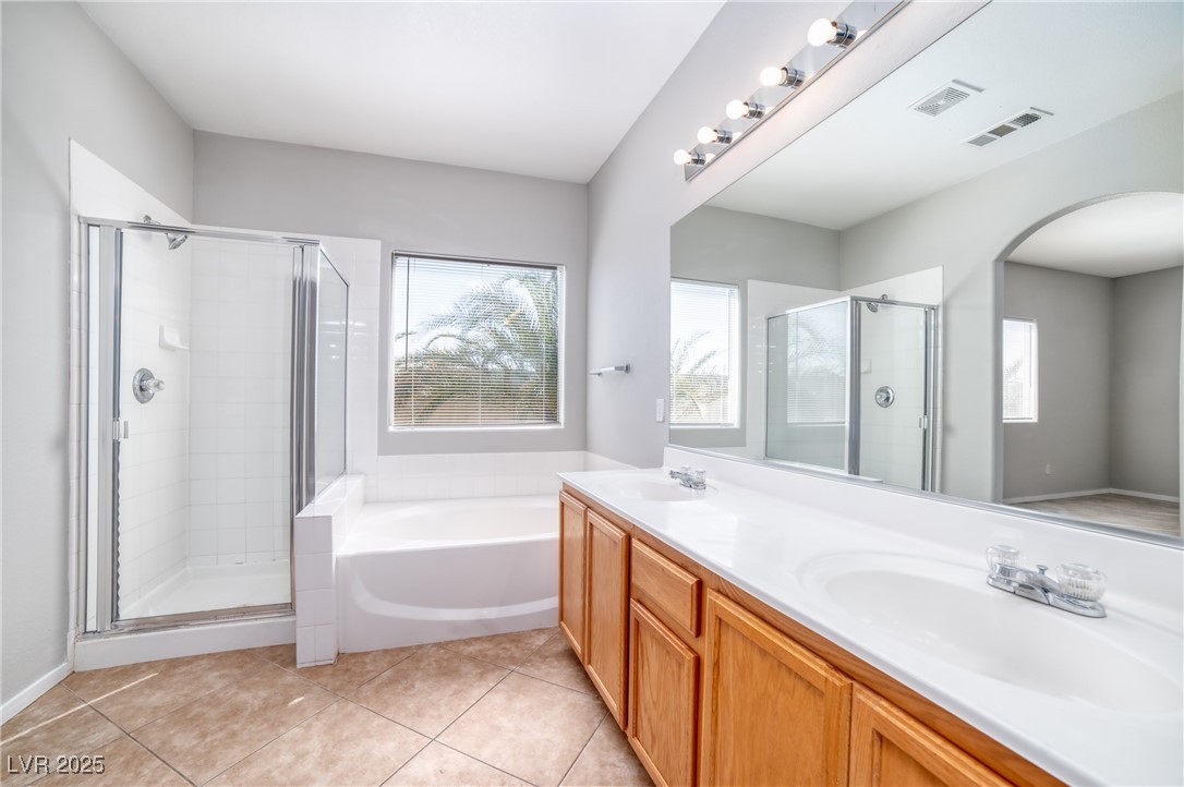 4020 Spring Line Street North Las Vegas, NV 89032 - Photo 17 of 29 Bathroom featuring double vanity, a stall shower, a bath, and light tile patterned floors