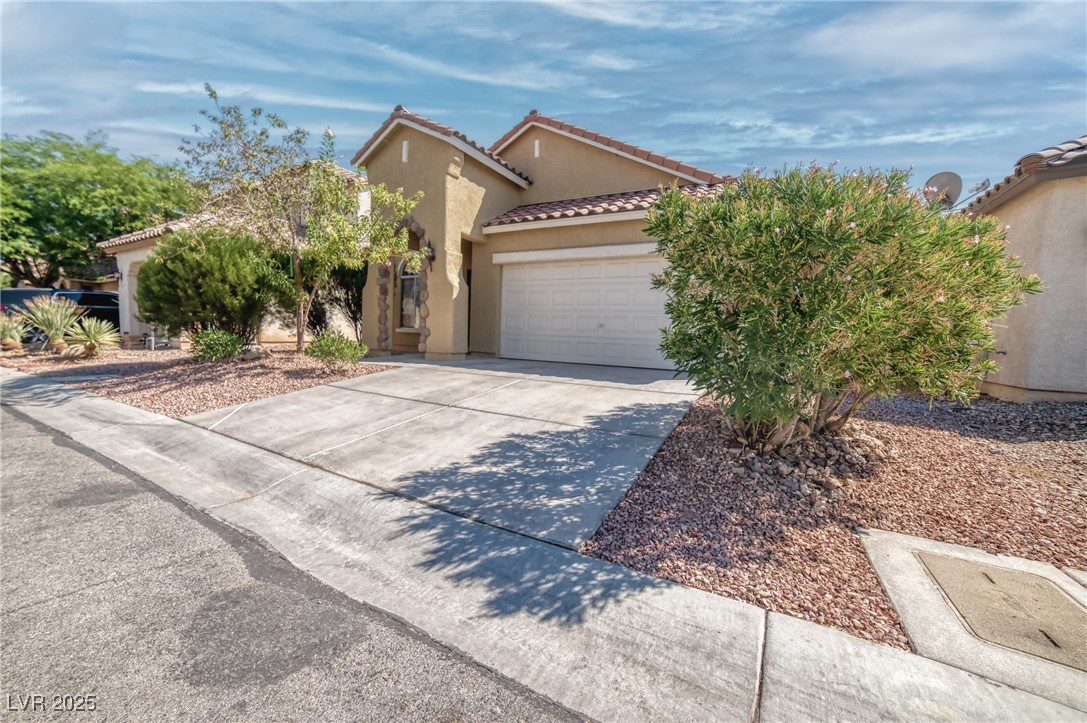4020 Spring Line Street North Las Vegas, NV 89032 - Photo 2 of 29 Mediterranean / spanish home with a tile roof, concrete driveway, stucco siding, and a garage