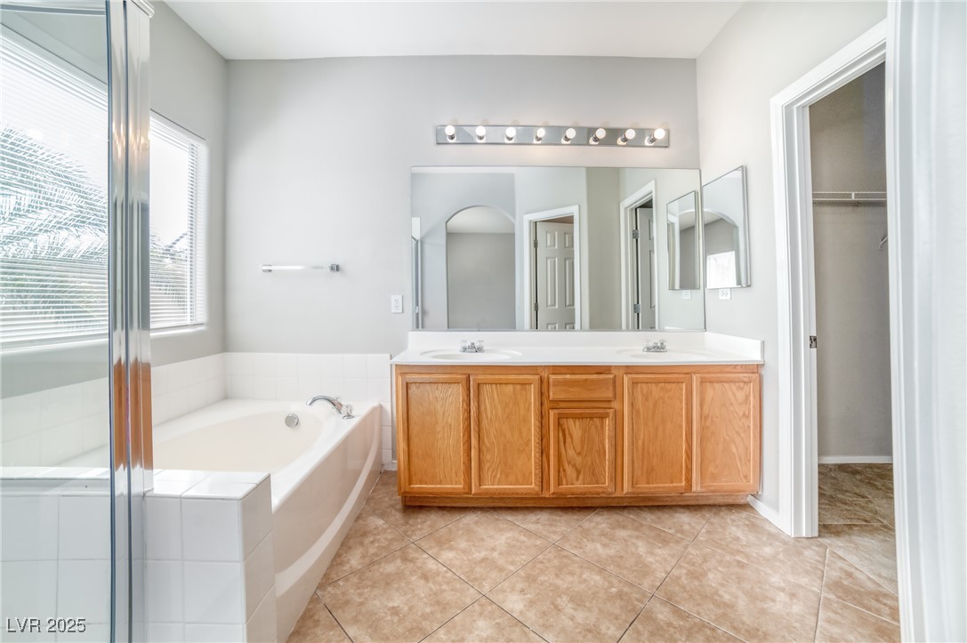 4020 Spring Line Street North Las Vegas, NV 89032 - Photo 19 of 29 Bathroom featuring a garden tub, double vanity, and light tile patterned floors