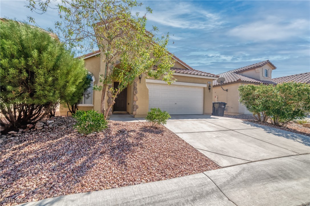 4020 Spring Line Street North Las Vegas, NV 89032 - Photo 3 of 29 View of front of home with concrete driveway, stucco siding, a tiled roof, and a garage