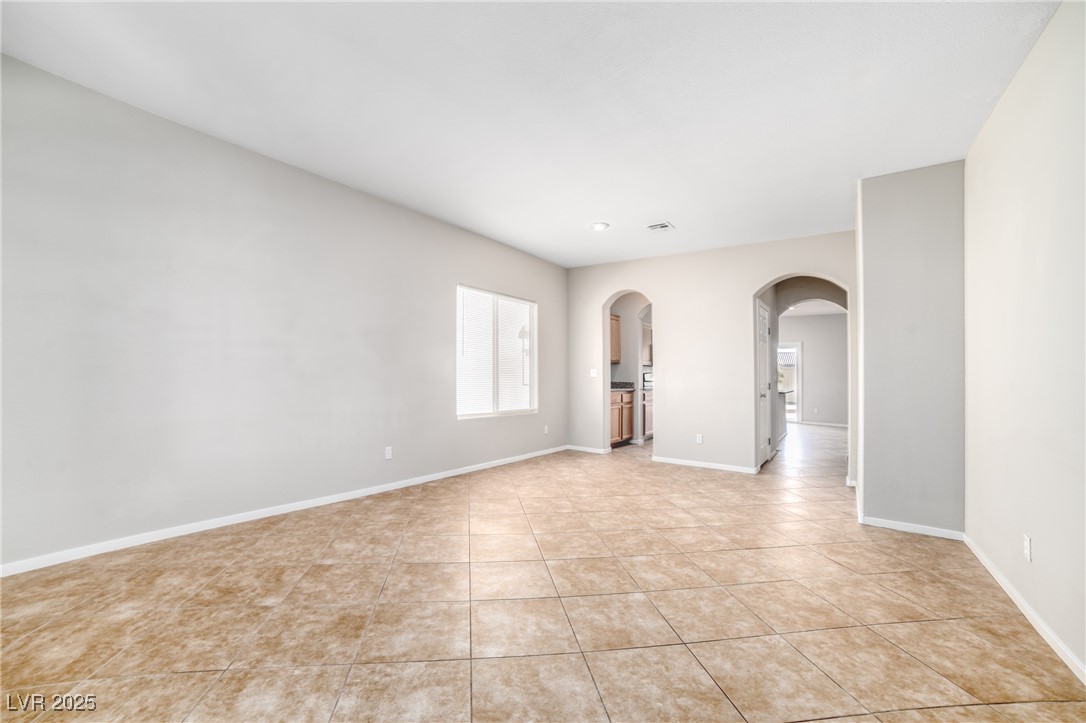 4020 Spring Line Street North Las Vegas, NV 89032 - Photo 4 of 29 Spare room featuring arched walkways and light tile patterned flooring