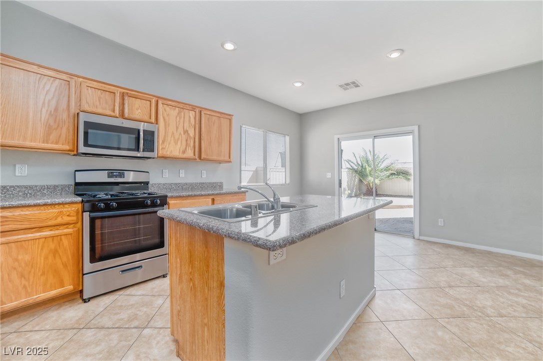 4020 Spring Line Street North Las Vegas, NV 89032 - Photo 6 of 29 Kitchen with stainless steel appliances, an island with sink, recessed lighting, and light tile patterned floors