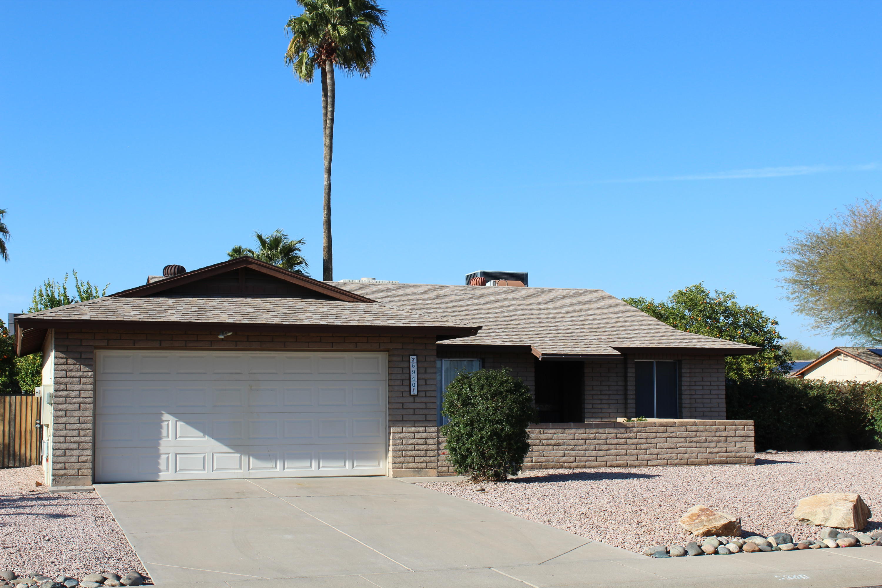 5940 East Spring Road Scottsdale, AZ 85254 - Photo 1 of 23 a front view of a house with a yard and garage