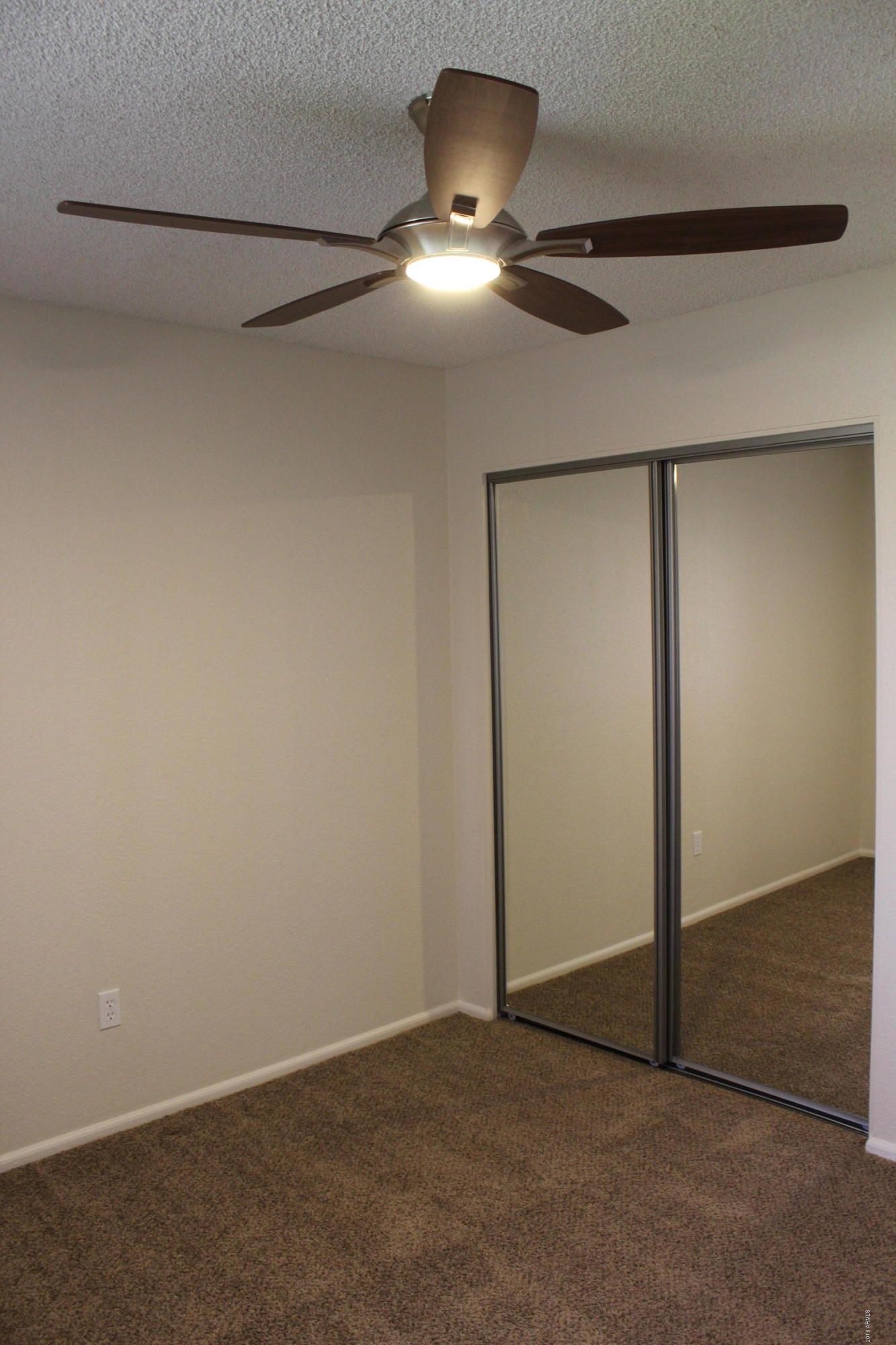 5940 East Spring Road Scottsdale, AZ 85254 - Photo 19 of 23 an empty room with a fan