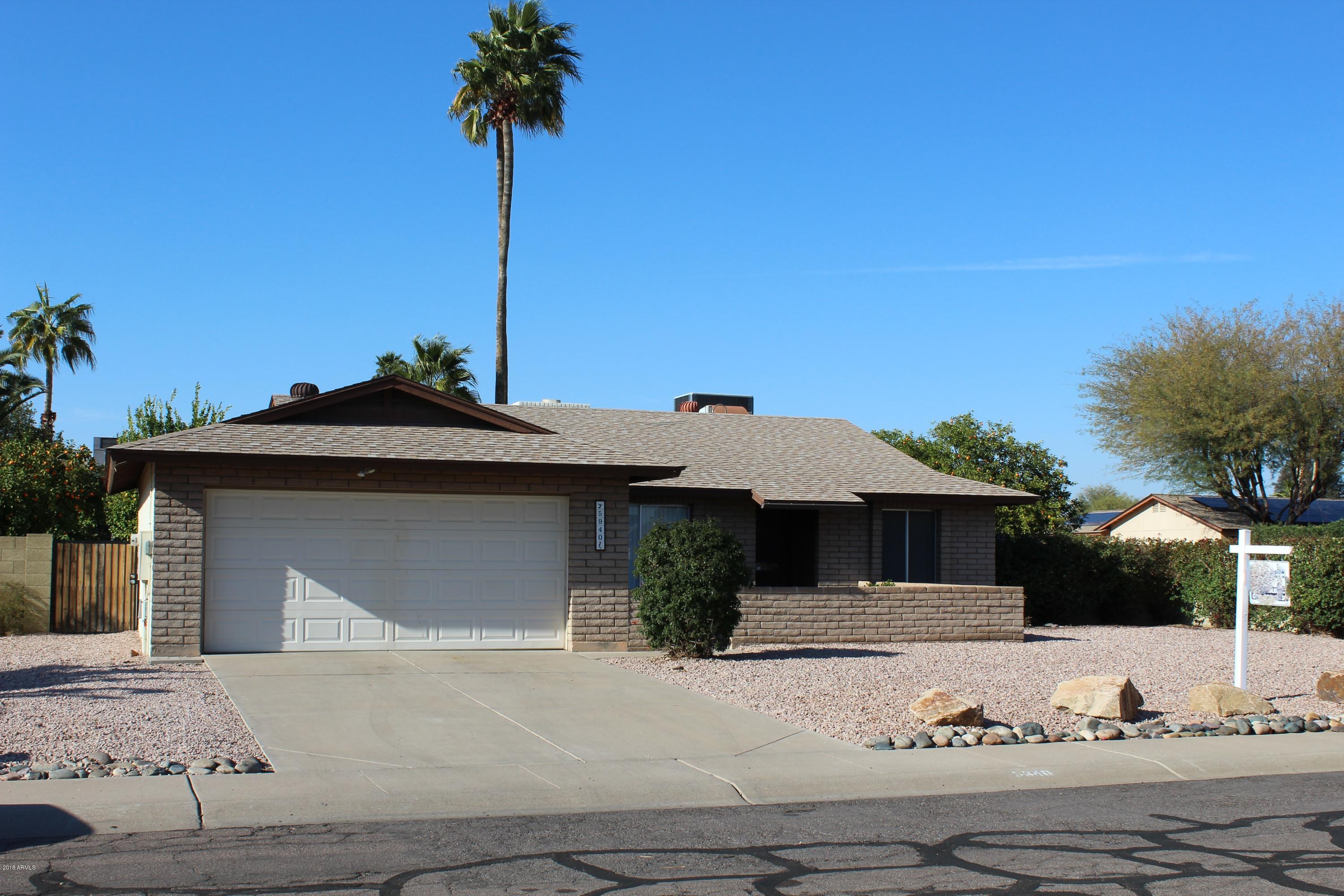 5940 East Spring Road Scottsdale, AZ 85254 - Photo 3 of 23 a front view of a house with garden
