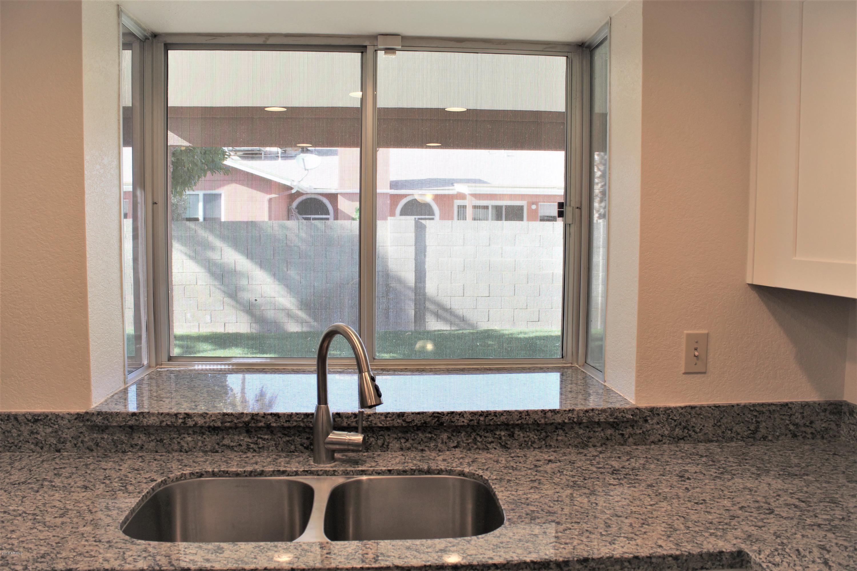 5940 East Spring Road Scottsdale, AZ 85254 - Photo 7 of 23 a kitchen with a sink and a window