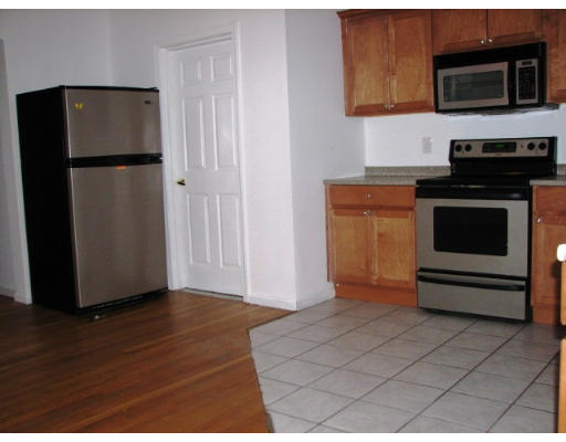 19 Burrell Street Boston, MA 02119 - Photo 3 of 20 a kitchen with a refrigerator stove and microwave