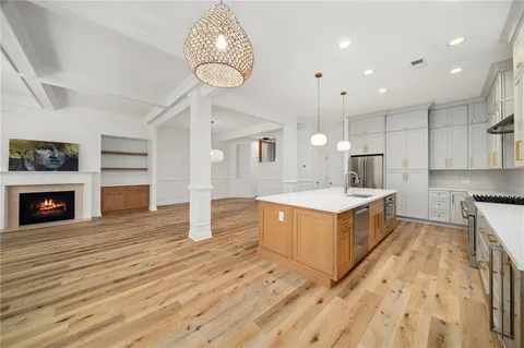a kitchen with wooden floors and cabinets