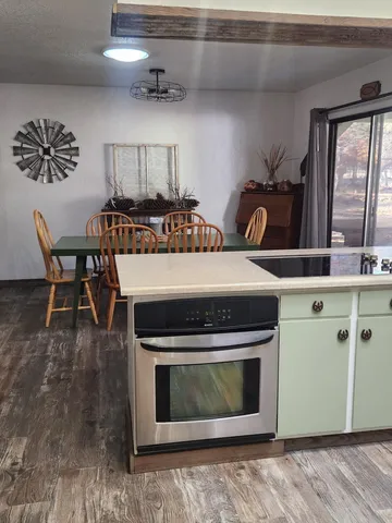 a stove top oven sitting inside of a kitchen