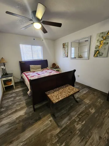 a bedroom with a bed and a chandelier
