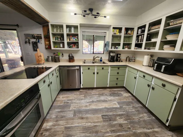 a kitchen with a sink cabinets and window