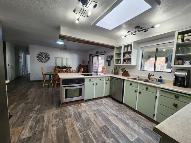 a kitchen with a sink cabinets and window