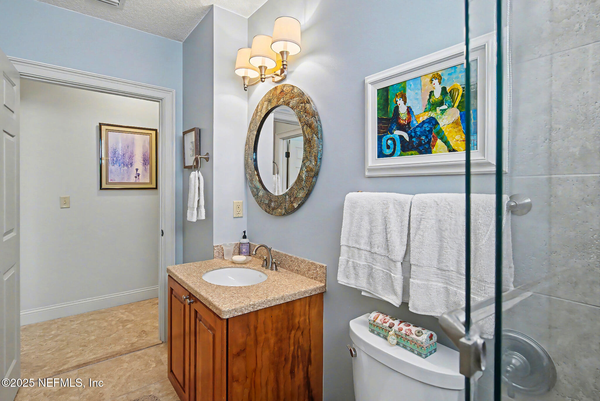 1 Radio Road, Unit 203 St. Augustine, FL 32084 - Photo 31 of 57 a bathroom with a sink a vanity and a painting on the wall