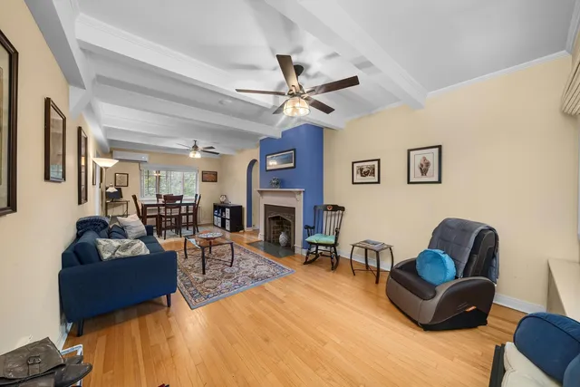 a living room with fireplace furniture and a fireplace