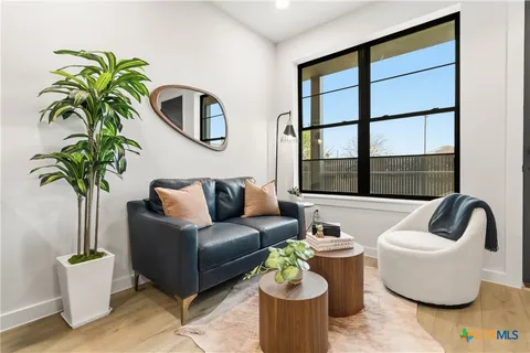 a living room with furniture and a potted plant