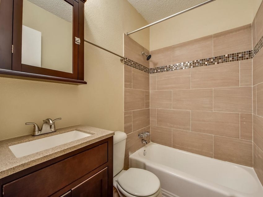 2401 Manor Road, Unit 119 Austin, TX 78722 - Photo 2 of 5 a bathroom with a sink a toilet and shower