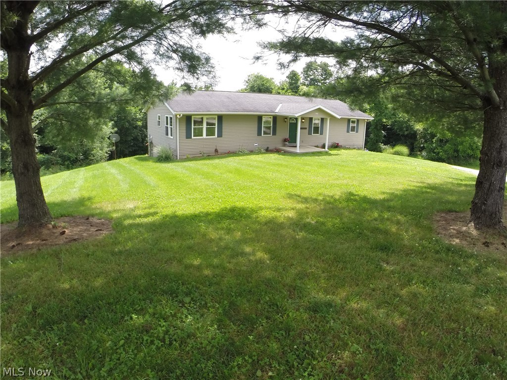 55101 Iowa Road Cumberland, OH 43732 - Photo 2 of 30 Large flat front yard great for kids and and single step entry into the home.