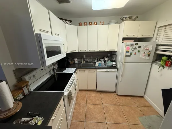 a kitchen with a stove a refrigerator and a sink