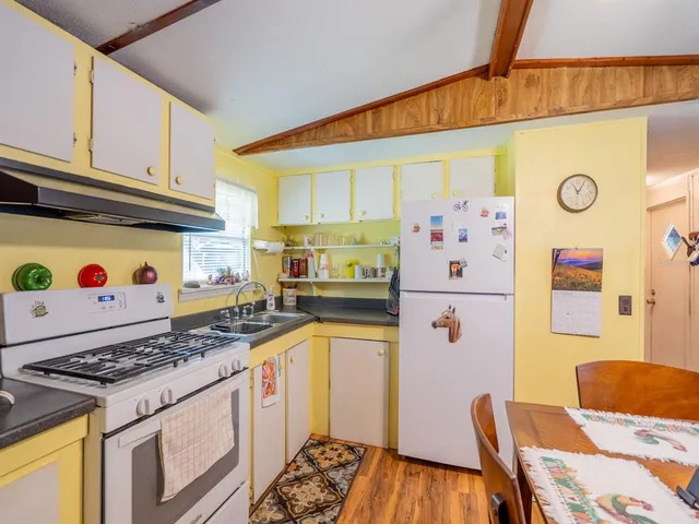 a kitchen with stainless steel appliances granite countertop a refrigerator and a stove top oven
