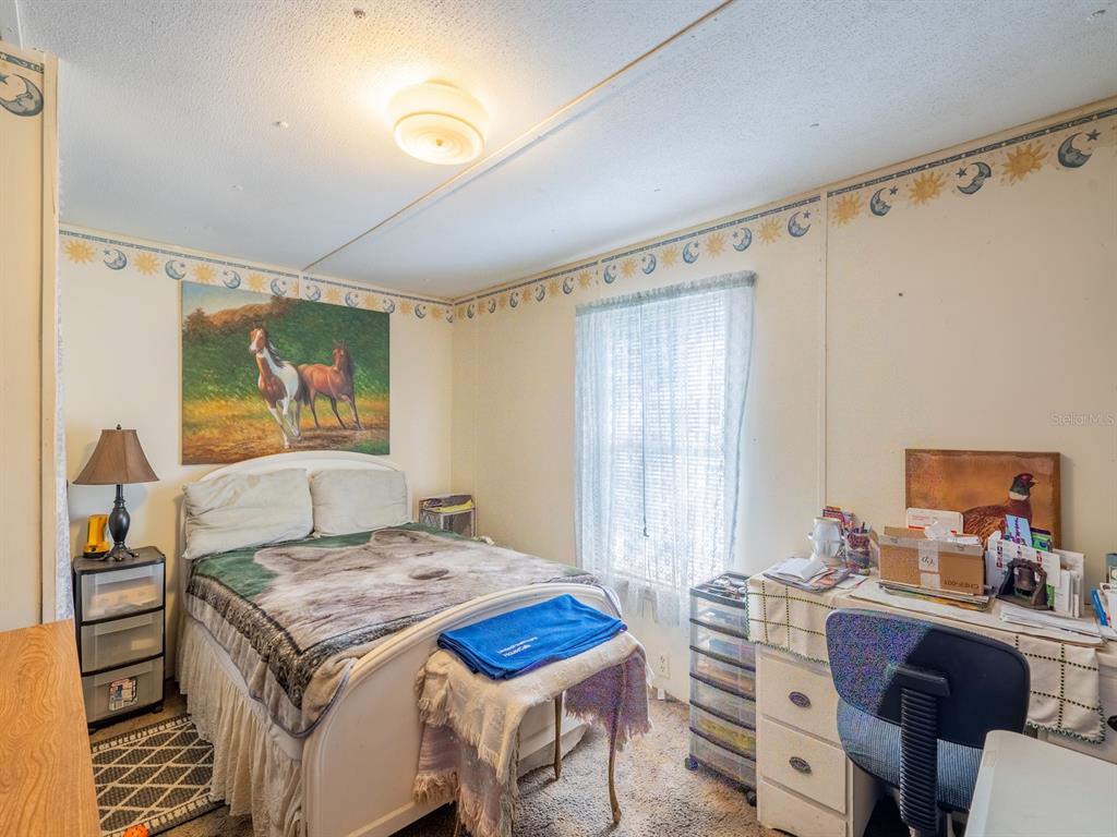 15429 Northeast 38th Court Citra, FL 32113 - Photo 14 of 53 a bedroom with a bed and furniture