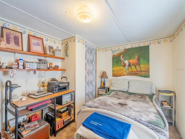 a bed room with a bed and a chandelier