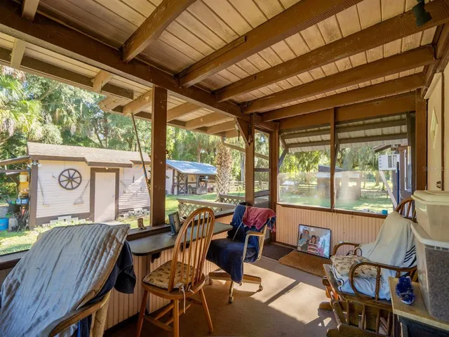 a view of a backyard with sitting area
